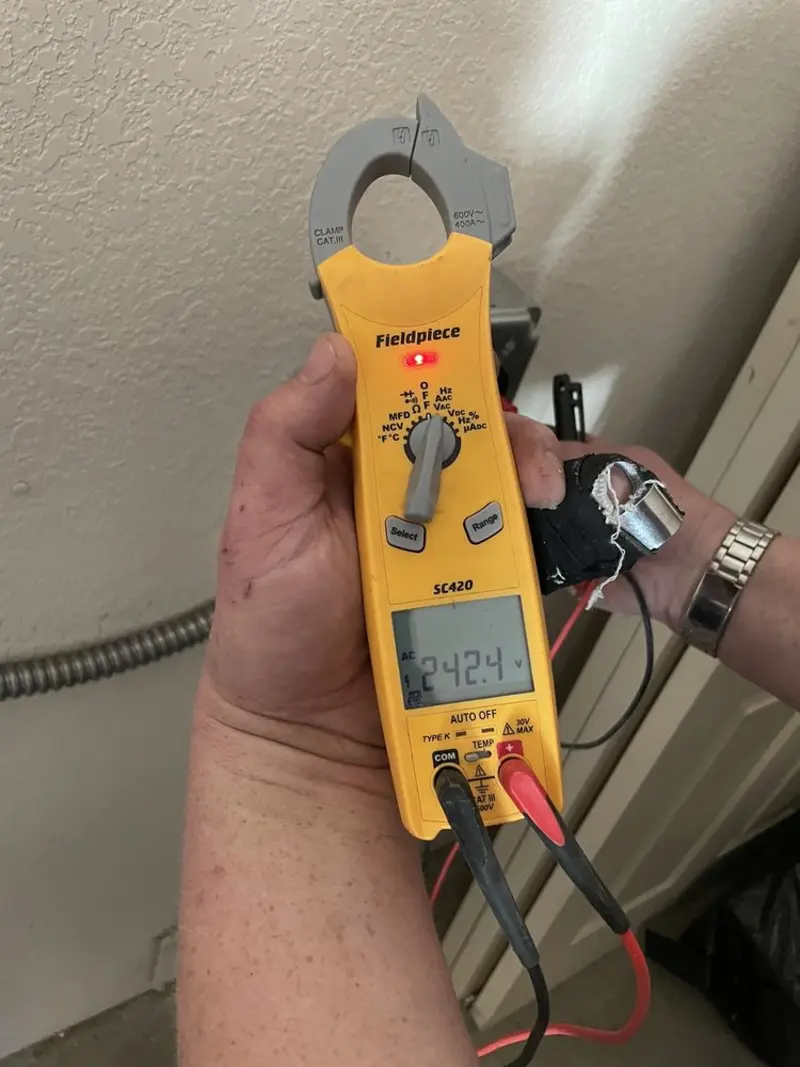 Voltage testing with clamp meter during Whole House Surge Protector in Moon